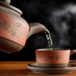 急須で中国茶を湯呑に煎れる